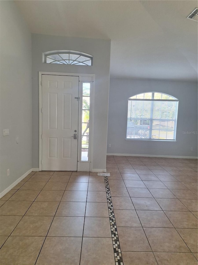 foyer entrance featuring a wealth of natural light and light tile patterned flooring