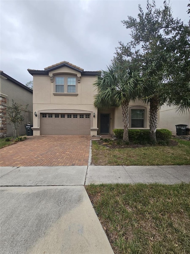 view of front of property featuring a garage and a front yard