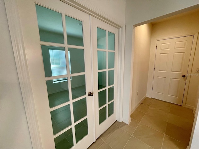 doorway to outside featuring light tile patterned floors and french doors