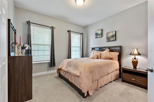 carpeted bedroom with multiple windows