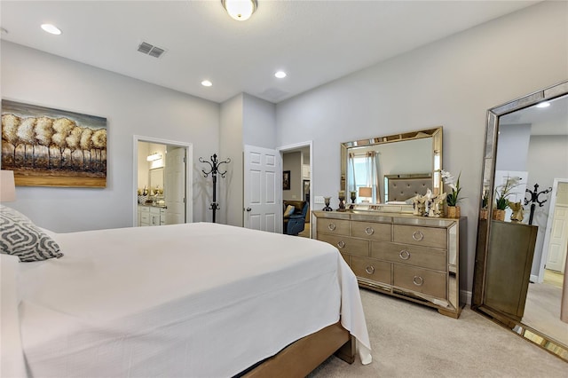 carpeted bedroom featuring ensuite bath