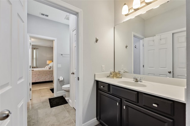 bathroom featuring vanity, toilet, and tile patterned flooring