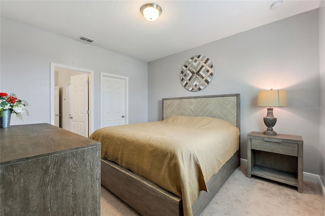 bedroom featuring light colored carpet