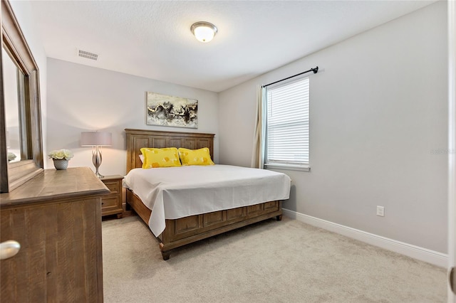 bedroom with light colored carpet