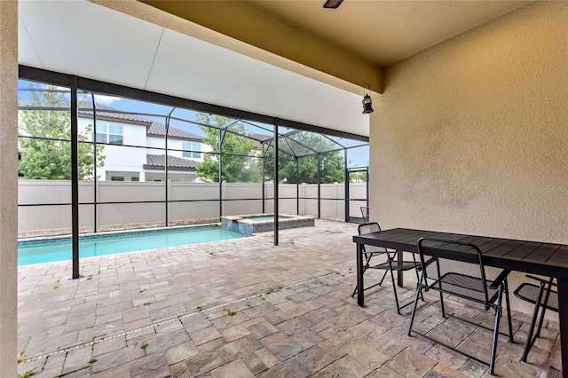 view of swimming pool with a patio, glass enclosure, and an in ground hot tub