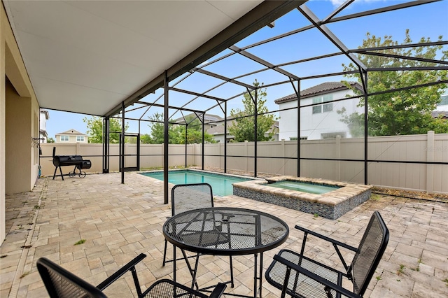 view of swimming pool with an in ground hot tub, grilling area, a lanai, and a patio area