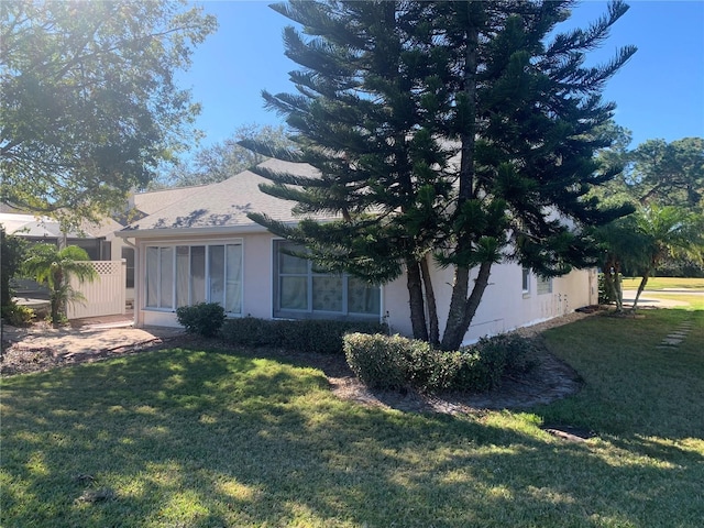 view of property exterior with a lawn