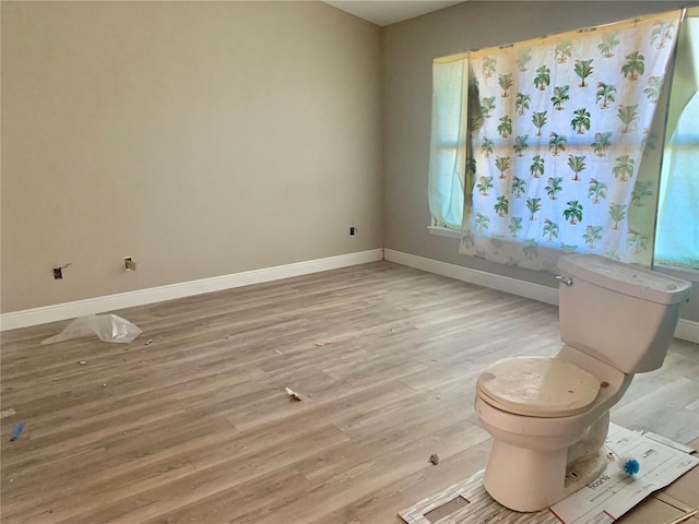 bathroom featuring hardwood / wood-style floors and toilet