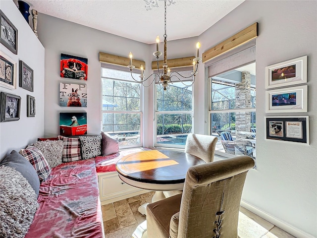 dining space featuring a notable chandelier and a textured ceiling