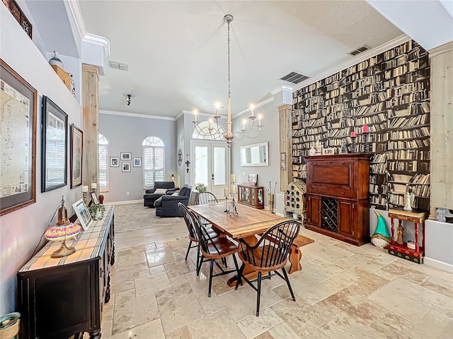 dining area featuring a notable chandelier, ornamental molding, and a textured ceiling