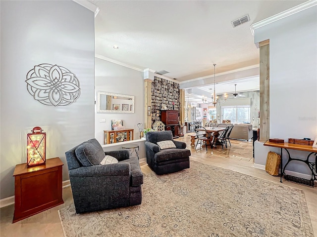 living room with ornate columns, ornamental molding, and a notable chandelier