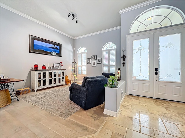 entrance foyer with crown molding and french doors