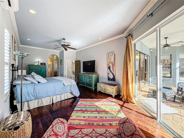 bedroom featuring multiple windows, hardwood / wood-style flooring, ornamental molding, and a textured ceiling