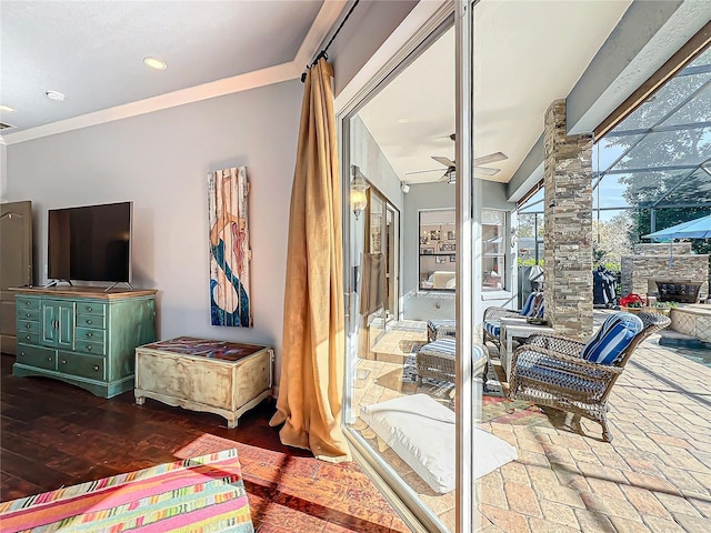 interior space featuring ceiling fan, ornamental molding, and hardwood / wood-style floors