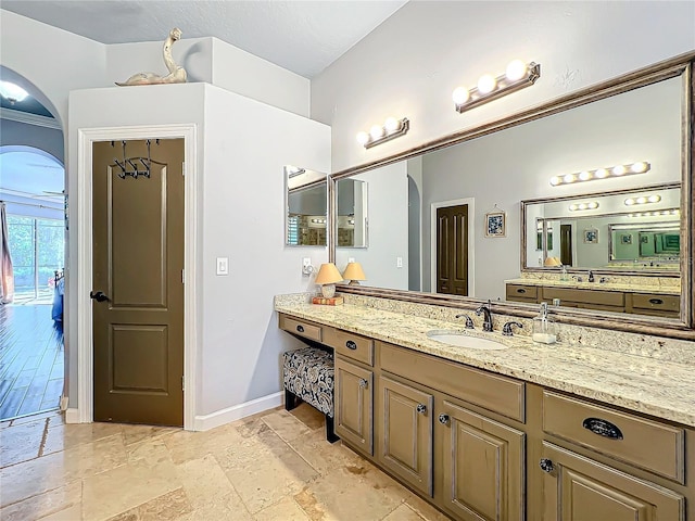 bathroom featuring crown molding and vanity