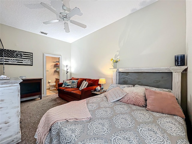 carpeted bedroom featuring vaulted ceiling, ensuite bathroom, ceiling fan, and a textured ceiling