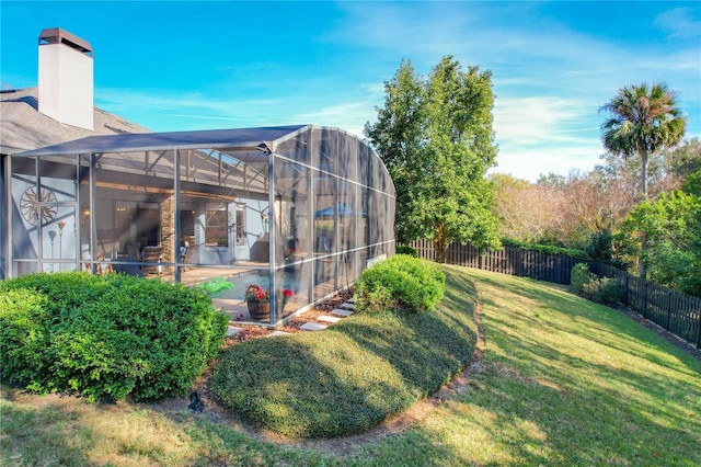 view of yard featuring a patio area and glass enclosure