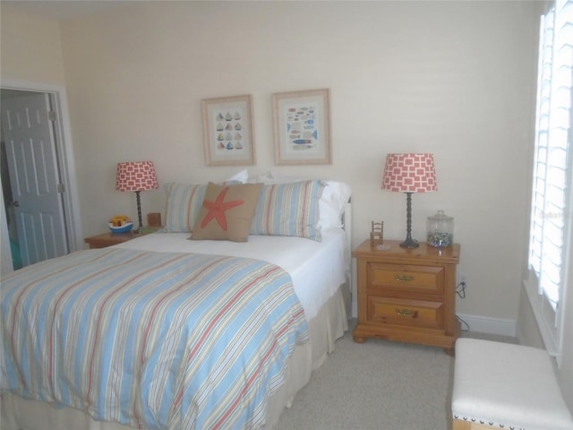 carpeted bedroom featuring multiple windows