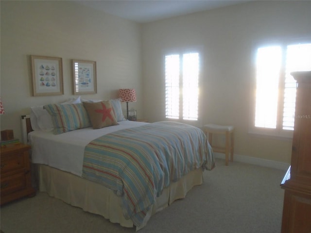 bedroom featuring light carpet