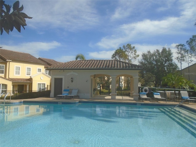 view of swimming pool with a patio and an outdoor structure