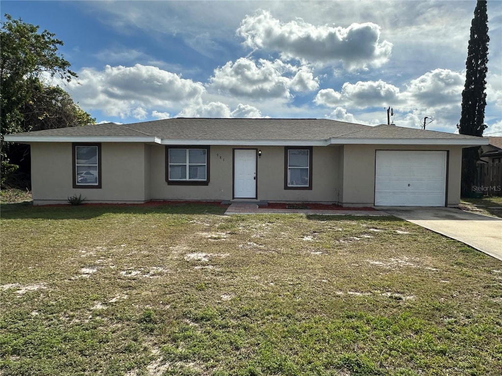 single story home with a garage and a front lawn