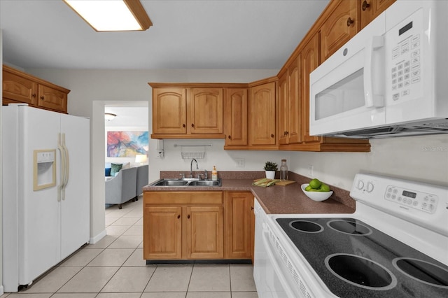 kitchen with white appliances, sink, and light tile patterned floors