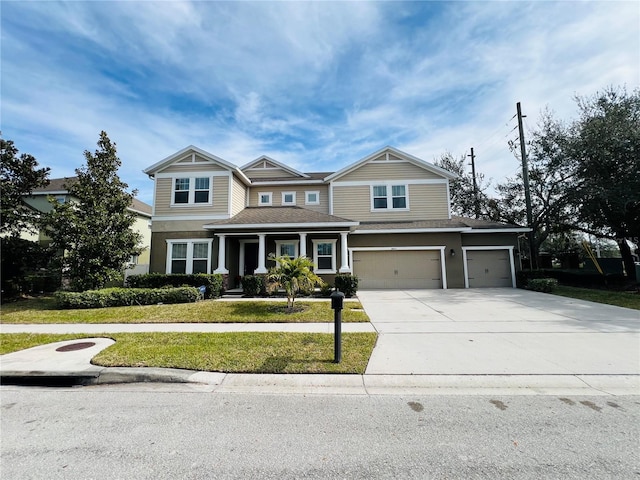 craftsman-style home with a garage and a front yard