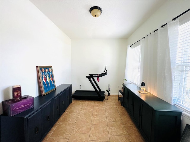 exercise room featuring light tile patterned flooring