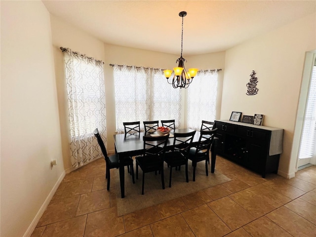 dining space with an inviting chandelier