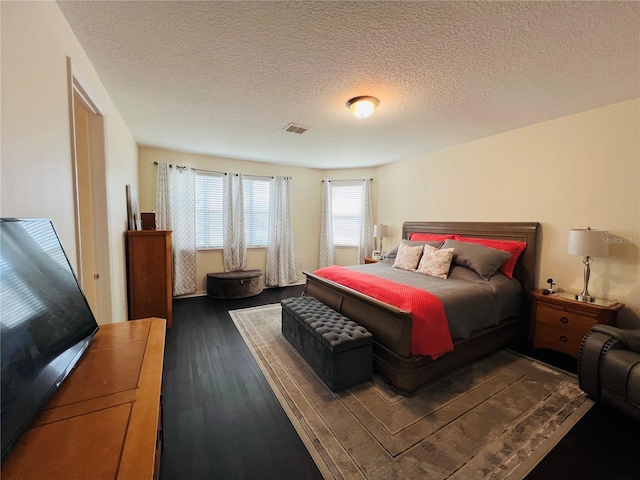 bedroom featuring hardwood / wood-style floors and a textured ceiling