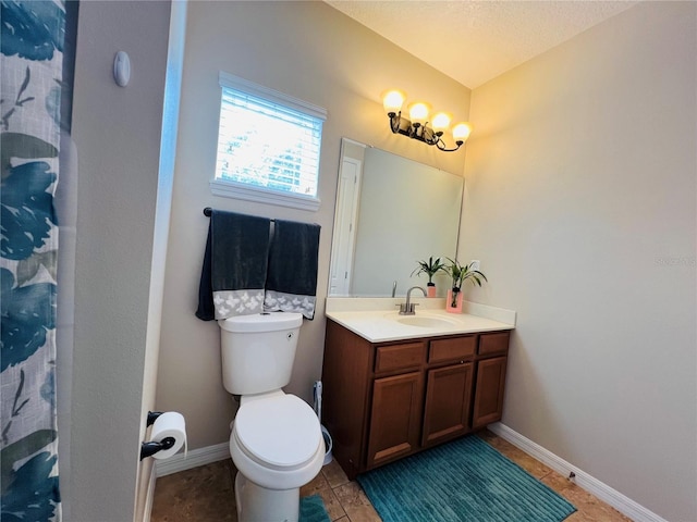 bathroom with vanity, a textured ceiling, and toilet