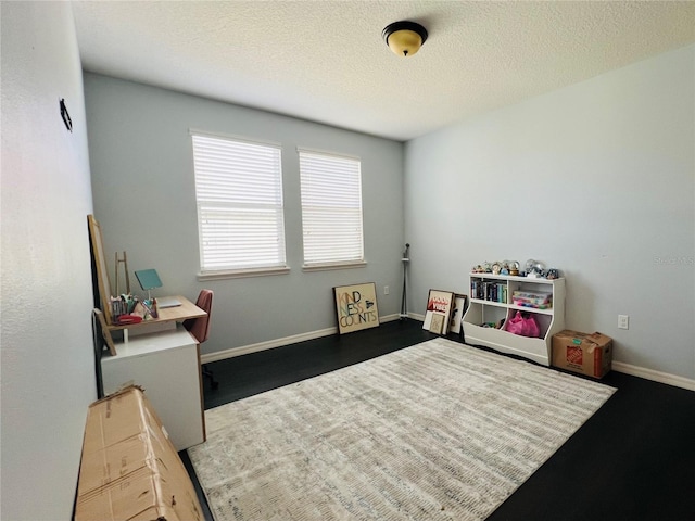 recreation room featuring a textured ceiling