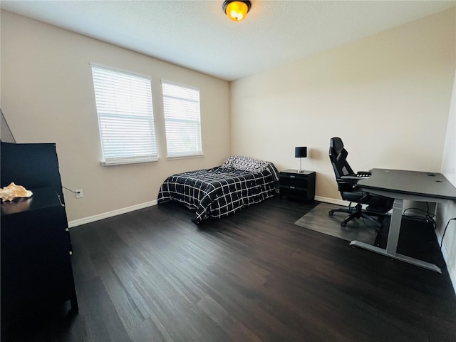 bedroom with dark hardwood / wood-style flooring