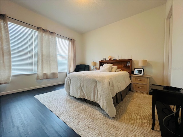 bedroom with lofted ceiling and light hardwood / wood-style floors