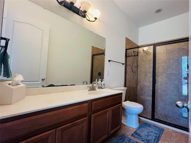 bathroom featuring vanity, tile patterned floors, a textured ceiling, and walk in shower