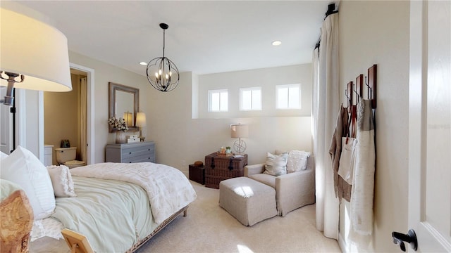 carpeted bedroom featuring a notable chandelier