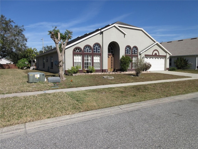 view of front of home with a garage and a front yard