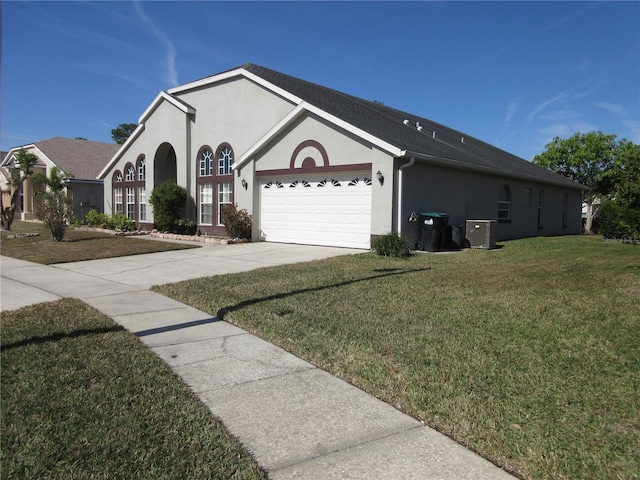 view of front facade featuring a garage, a front lawn, and central air condition unit