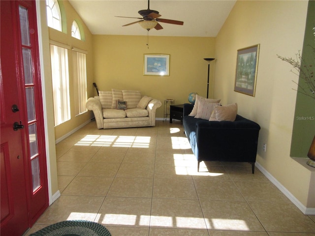 living room with vaulted ceiling, ceiling fan, and light tile patterned flooring