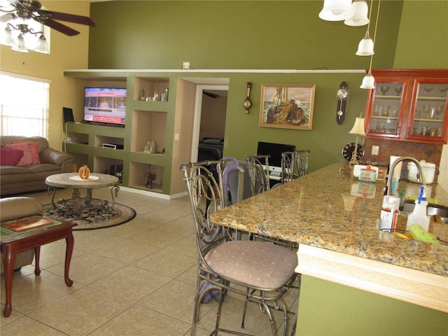 tiled dining area with sink and ceiling fan