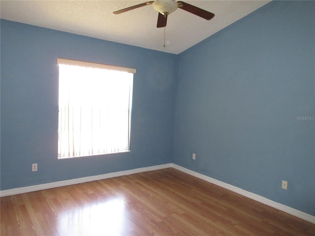 spare room featuring hardwood / wood-style floors, a textured ceiling, and ceiling fan