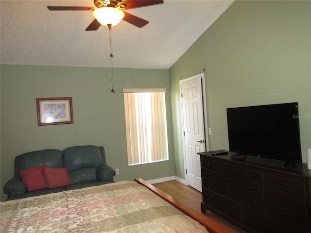 bedroom featuring vaulted ceiling, hardwood / wood-style floors, and ceiling fan