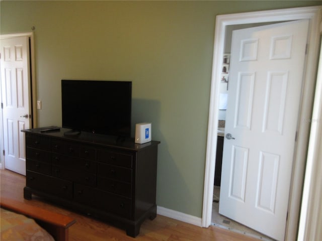 bedroom with wood-type flooring