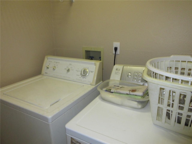 clothes washing area featuring separate washer and dryer