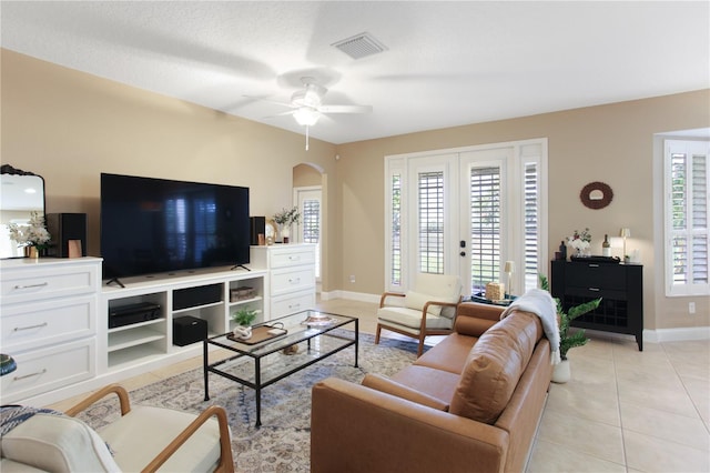 living room with ceiling fan, french doors, light tile patterned flooring, and a wealth of natural light