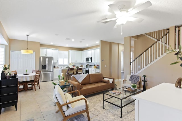 tiled living room featuring ceiling fan