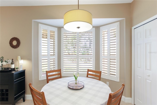 dining room featuring plenty of natural light and light tile patterned flooring