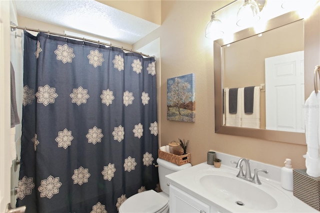 bathroom with toilet, a textured ceiling, a shower with shower curtain, and vanity