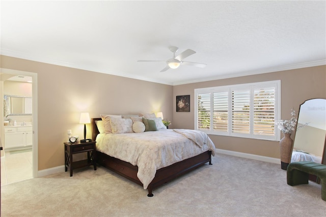 carpeted bedroom featuring ensuite bathroom, ceiling fan, ornamental molding, and sink