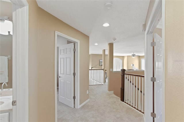 hallway with light colored carpet